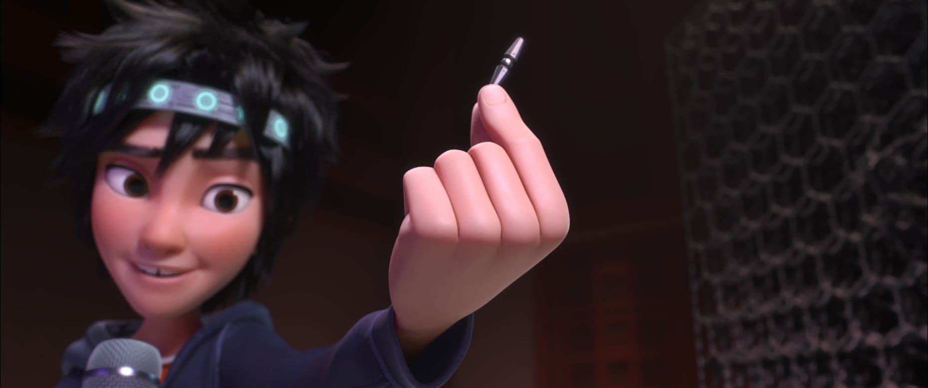 Hiro holds one fictional microbot beside a larger assembled microbot structure.